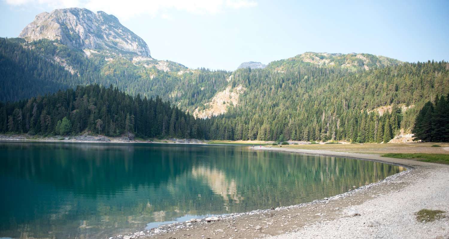 Black Lake in Durmitor National Park surrounded by mountains and pine forests