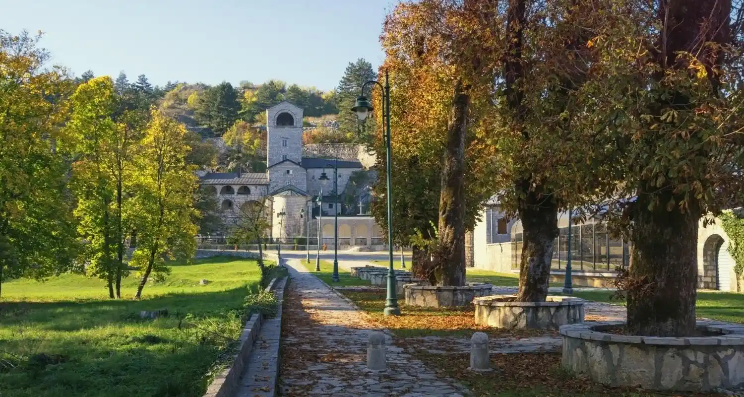 Cetinje Monastery surrounded by a park and autumn trees in Cetinje