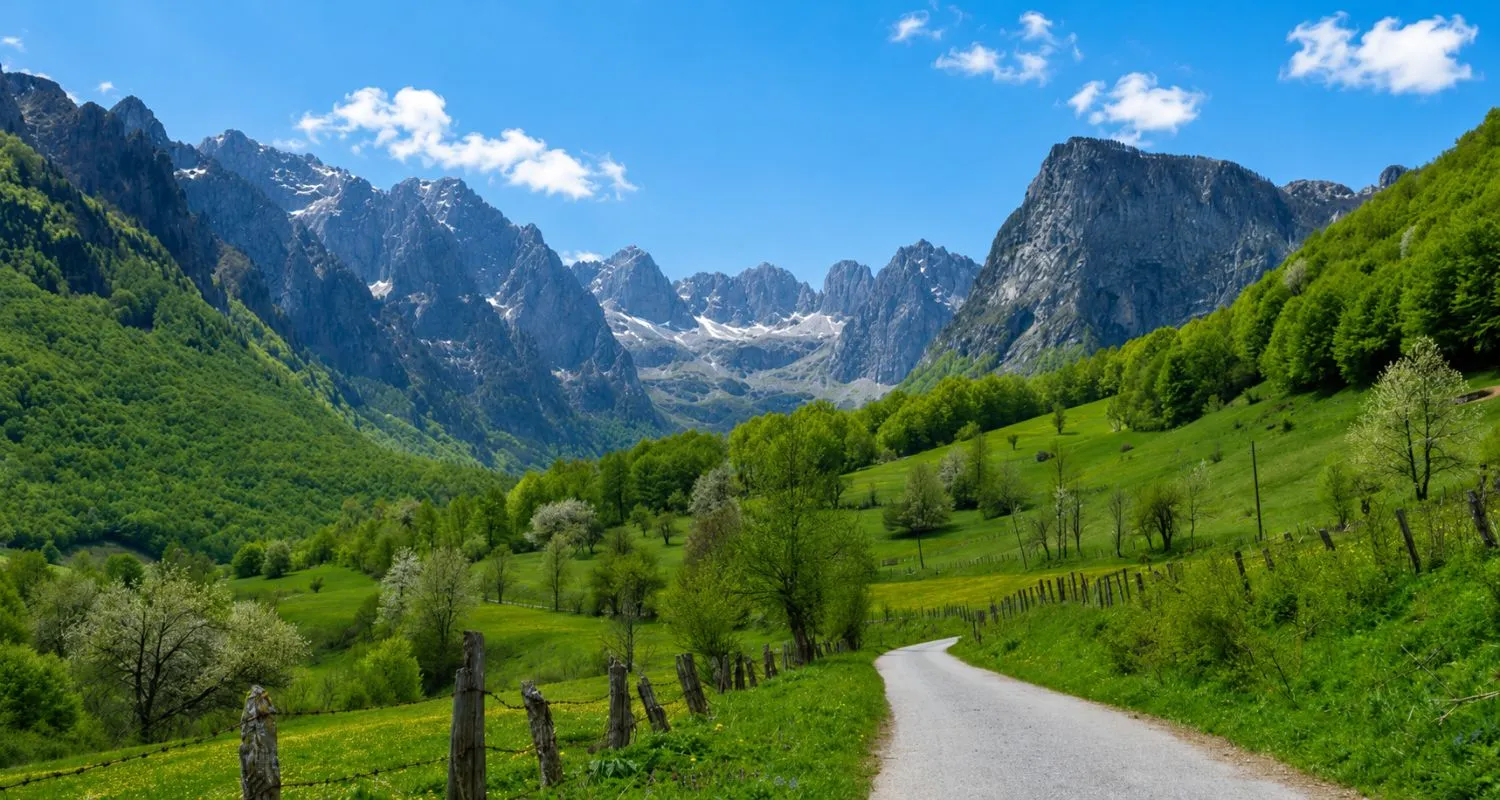 Road through the green Grebaje Valley beneath the peaks of Prokletije National Park