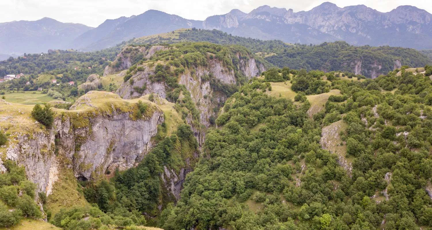 Nevidio canyon near Durmitor with forested slopes and mountain peaks in the distance