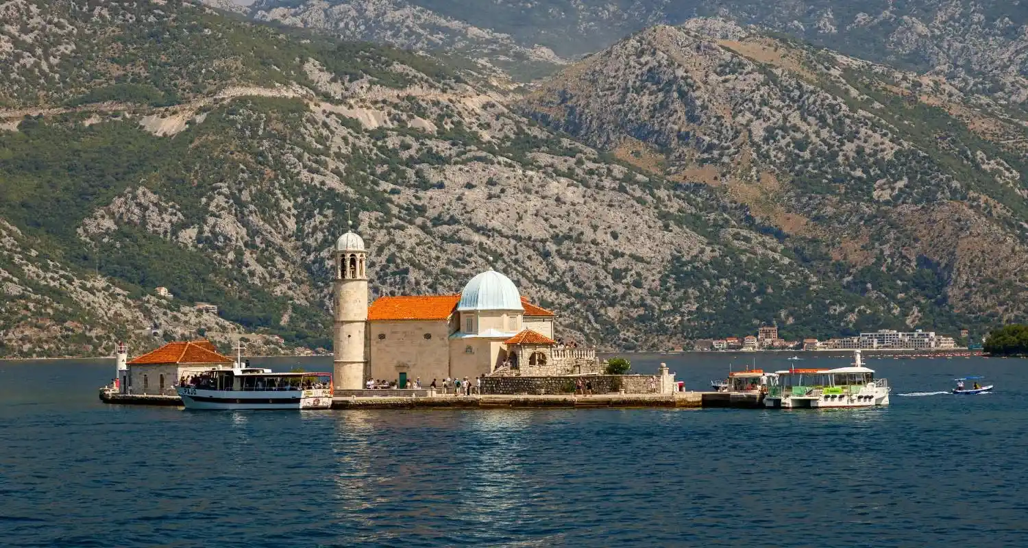 Our Lady of the Rocks island near Perast with the church, boats, and mountains of the Bay of Kotor