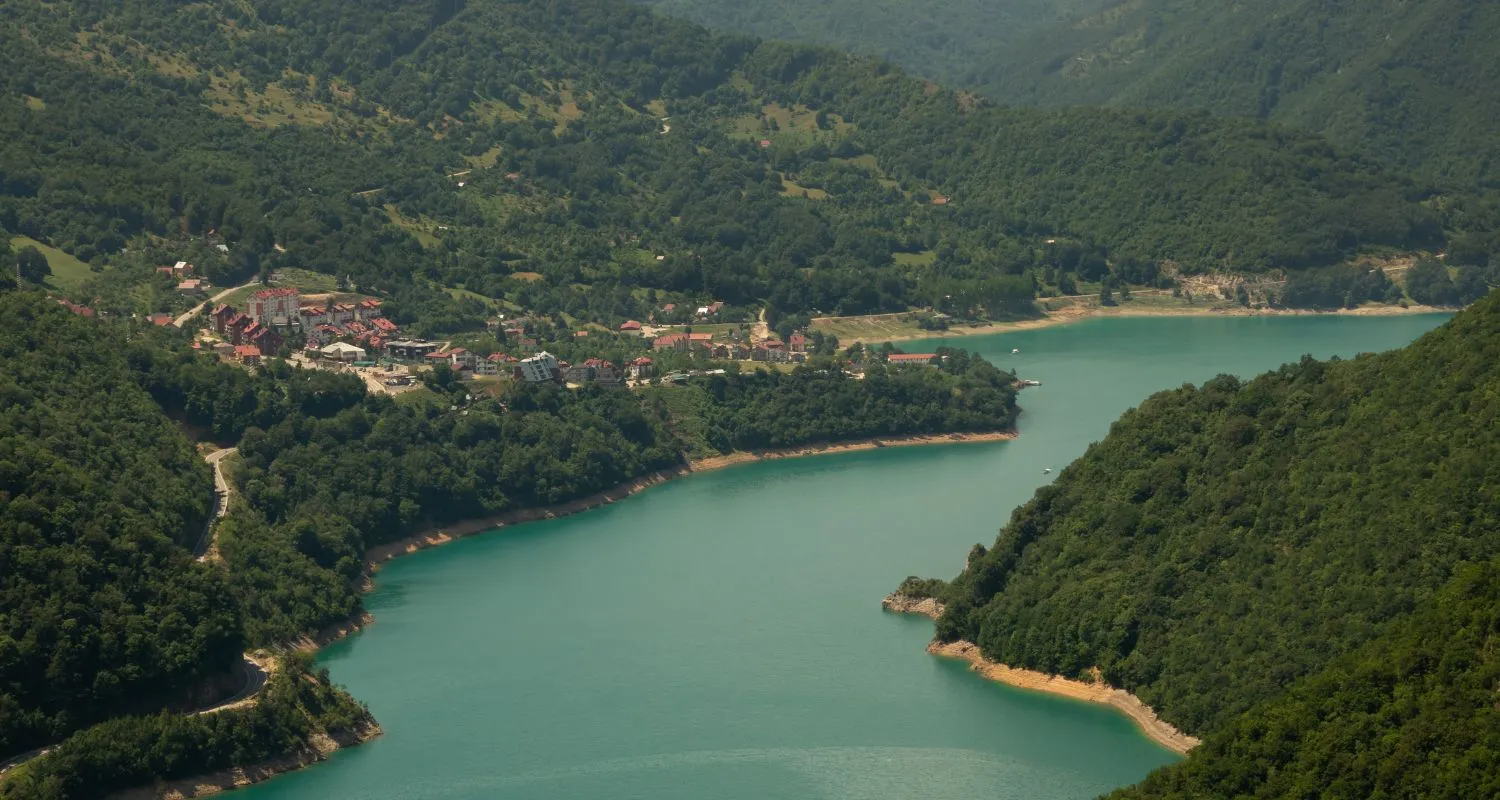 Plužine on the shore of Piva Lake surrounded by the forested mountains of northern Montenegro