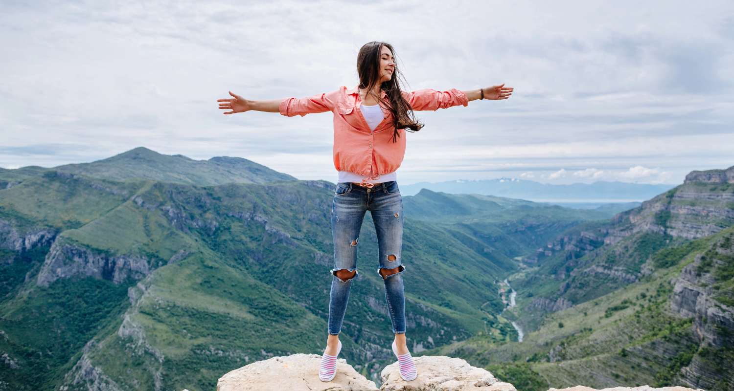 Solo female traveler enjoying a mountain viewpoint in Montenegro, showing why is Montenegro safe for women traveling alone